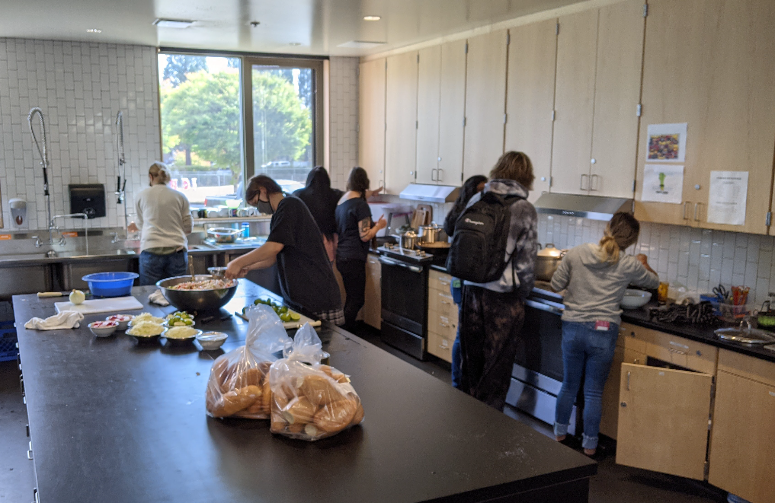 Culinary students prepare the weekly Community Lunch at Creekside Community High School, earning a partial internship credit and real life skills in catering
